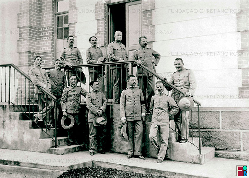 Cel. Achilles Veloso Pederneiras, primeiro Diretor da Fábrica de Pólvora sem Fumaça, com sua diretoria. Foto de 1913.
